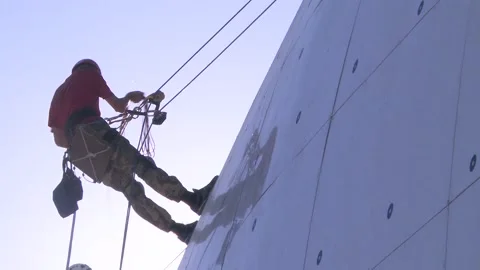 The industrial climber prepares for work at height early in the morning Stock Footage 98306328