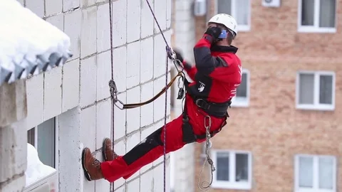 Industrial climber talking on a mobile phone Stock Footage 72709736