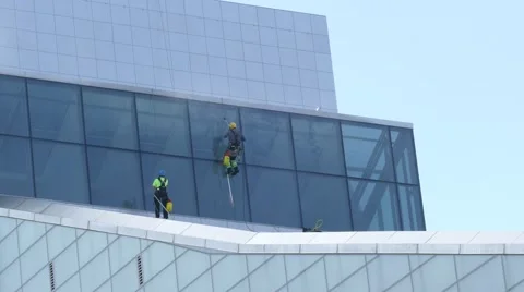 Industrial Climbers - Window washers clean facade of New Building Stock-Footage 67567688