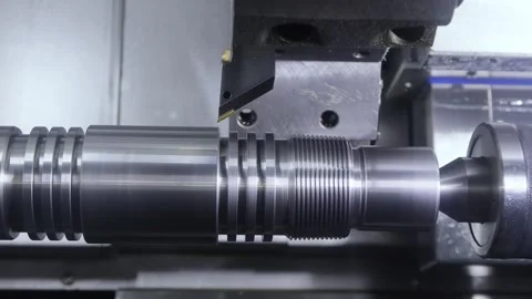 Industrial cnc lathe machine cutting grooves on metal part in factory works.. Stock Footage 337348380