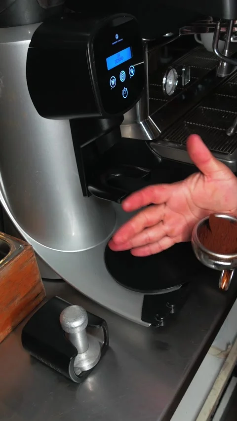 Industrial coffee grinder preparing fresh espresso grounds Video stock 343912590