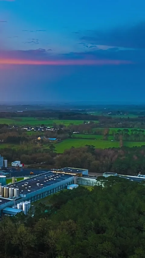 Industrial Complex Beside Forest Under Colorful Evening Sky Stock Footage 342311449