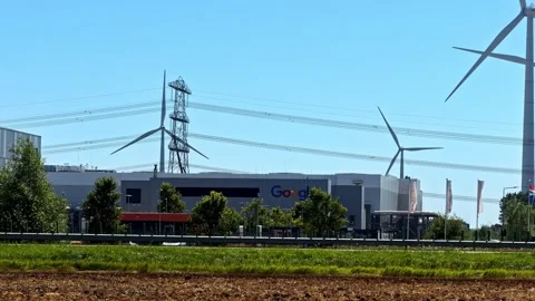 Industrial complex with a Google data center and wind turbines generating clean Stock Footage 347706617