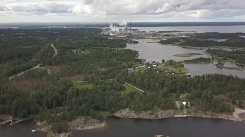 Industrial Complex in Horizon with Forest Next to Sea shown Vídeo Stock 135937420
