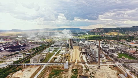Industrial complex located in a hilly area near a river, showing various 動画素材 341128934