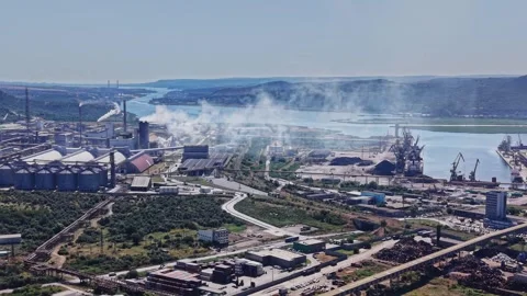 Industrial complex near river with production and smoke in the air Stock Footage 339648601