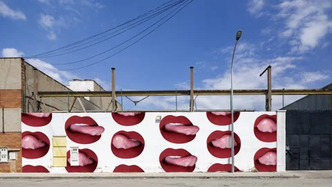 Industrial complex overlayed with red lips visuals on the brick wall Stock-Footage 316183784