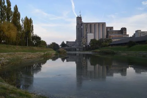Industrial complex reflection in the filthy water Stock Photos