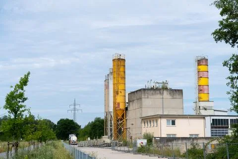 Industrial complex with yellow silos Stock Photos