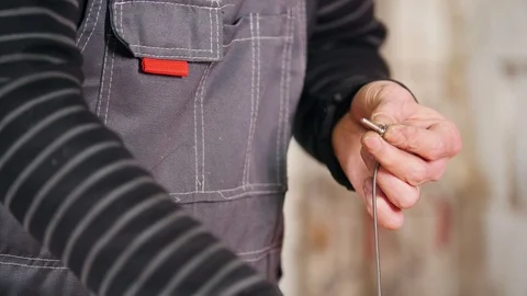 Industrial concept. A man worker wrap the screw with a wire Vídeo Stock 105162011