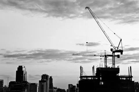 Industrial construction cranes and city Stock Photos