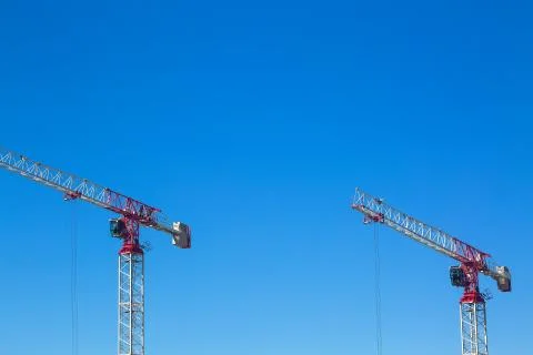 Industrial construction cranes or column-jib cranes with cabin are working on Stock Photos