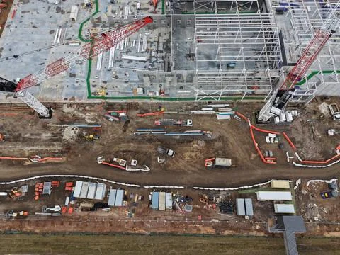 Industrial construction site with cranes developing new facility Stock Photos