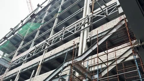 Industrial construction site showing structural steel framework and scaffol.. Stock Footage 329090896