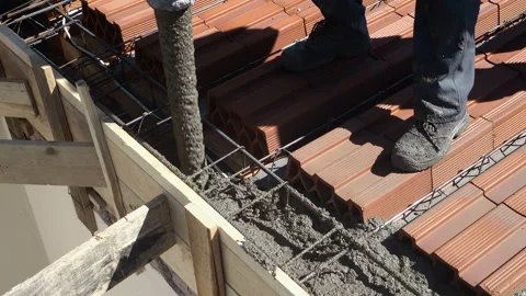 Industrial construction workers using automatic pump tube for pouring cement  Stock Footage 138906059