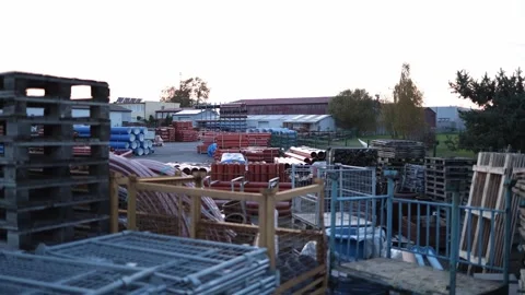 Industrial construction yard with stacks of metal and plastic pipes stored outdo Stock Footage 319833155