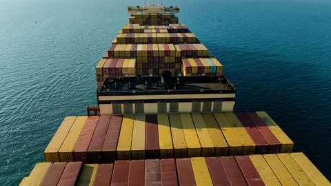 Industrial Container Ship Navigating Open Ocean Waters Birds Eye View Stock Photos