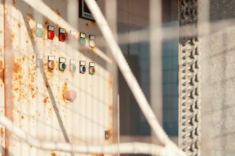 Industrial control panel with colorful push buttons and rusty metal surface.. Stock Photos