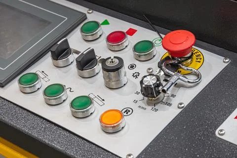 Industrial control panel with emergency button, circular metallic buttons, .. Stock Photos