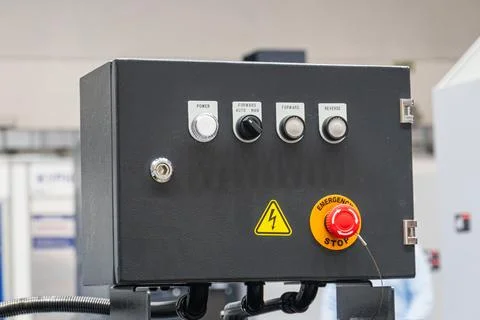 Industrial control panel with emergency stop button, power switch, rotary s.. Stock Photos