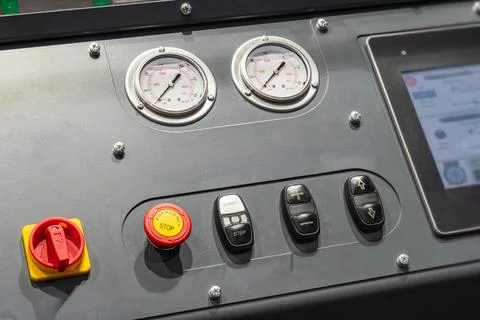 Industrial control panel featuring digital display, emergency stop button, .. Stock Photos