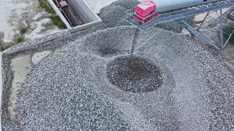 Industrial conveyor and loader. Drone captures activity at gravel stockpile site Stock Footage 337912584