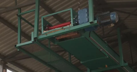 Industrial conveyor machine with electric motor and metal framework beneath 스톡 동영상 346315662
