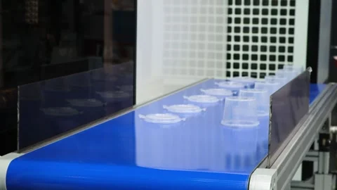 Industrial conveyor for producing plastic packaging using PVC extrusion. Plas Stock Footage 344381813