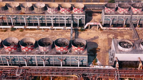 Industrial cooling towers with checkered patterns at factory complex Stock Footage 340080208