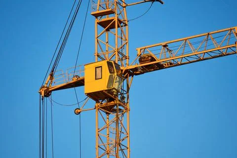 Industrial crane in action at a skyscraper construction site 写真素材