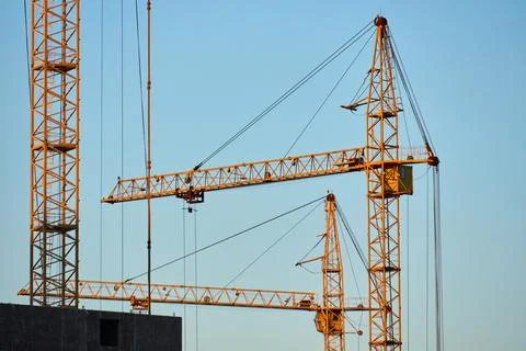 Industrial crane in action at a skyscraper construction site 写真素材