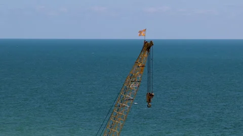 Industrial Crane Boom with Hook Above Open Sea Video stock 346502280