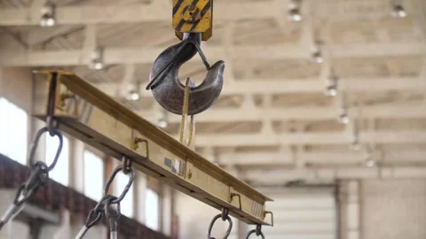 Industrial crane hook hanging in large warehouse in industrial workshop. Video stock 313815433