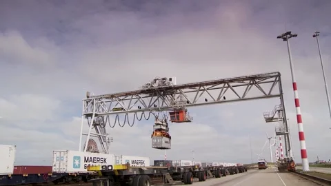 Industrial Crane Loading Shipping Container Onto Freight Train at Outdoor Termin Stock Footage 334053501