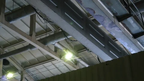 Industrial crane moves under ceiling of spacious metal production workshop Stock Footage 115960953