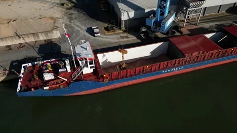Industrial crane unloading cargo ship at Southampton Docks UK aerial Stock Footage 257250165