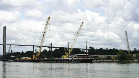 Industrial cranes working on a river construction site 스톡 동영상 341817016