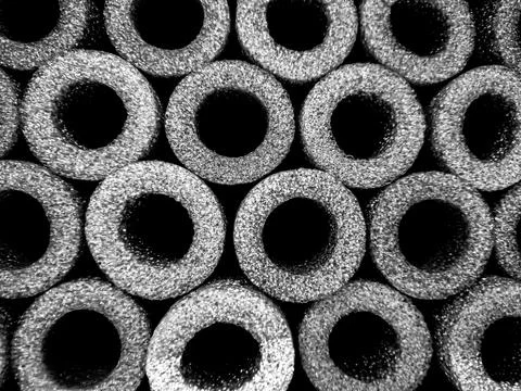 Industrial dark abstract view of cylindrical shapes arranged in a pattern s.. Ilustración de archivo