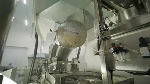 Industrial deep frying machine, chips are fried in a large bowl with oil. Stock Footage 147407734