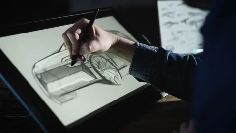An industrial designer develops a new car concept. A man uses a professional Stock Footage 192255075