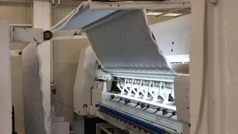 Industrial device that quilts a material that will cover the mattresses with Stock Footage 148341390