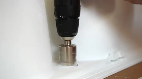 Industrial diamond core bit rotating and drilling hole in white ceramic tile Stock-Footage 162108138