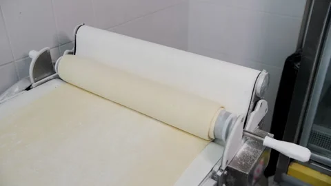 Industrial Dough Sheeter Rolling Fresh Pastry Dough Stock Footage 321286880