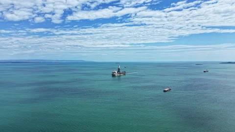 Industrial dredging vessel operates in open water under cloudy sky near coast Stock Footage 340144014