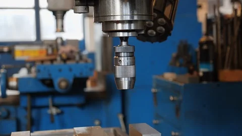 Industrial drilling machine in metal workshop - camera orbiting Stock Footage 126021098