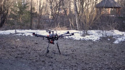 Industrial Drone Hovering in Forested Area Before Takeoff Stock Footage 314303456