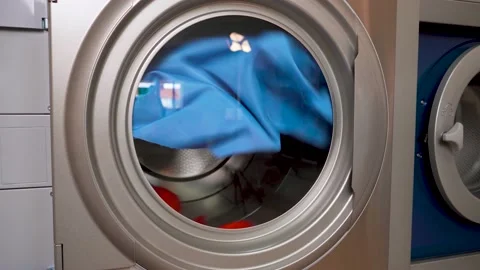 Industrial dryer machine working close-up of drying clothes in drying machine Stock Footage 153459309