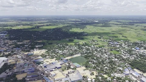Industrial Edge of Town Beside Patchy Green Farmland on Cloudy Day Stock Footage 344272279