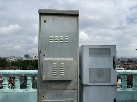 Industrial electrical boxes sit atop a rooftop Stock Photos