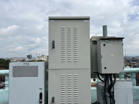 Industrial electrical boxes sit atop a rooftop Stock Photos